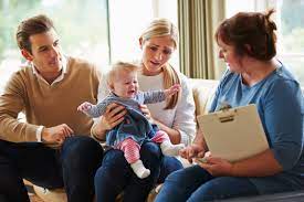 Caseworker talking with young couple with concerns about SafeSleep360°.